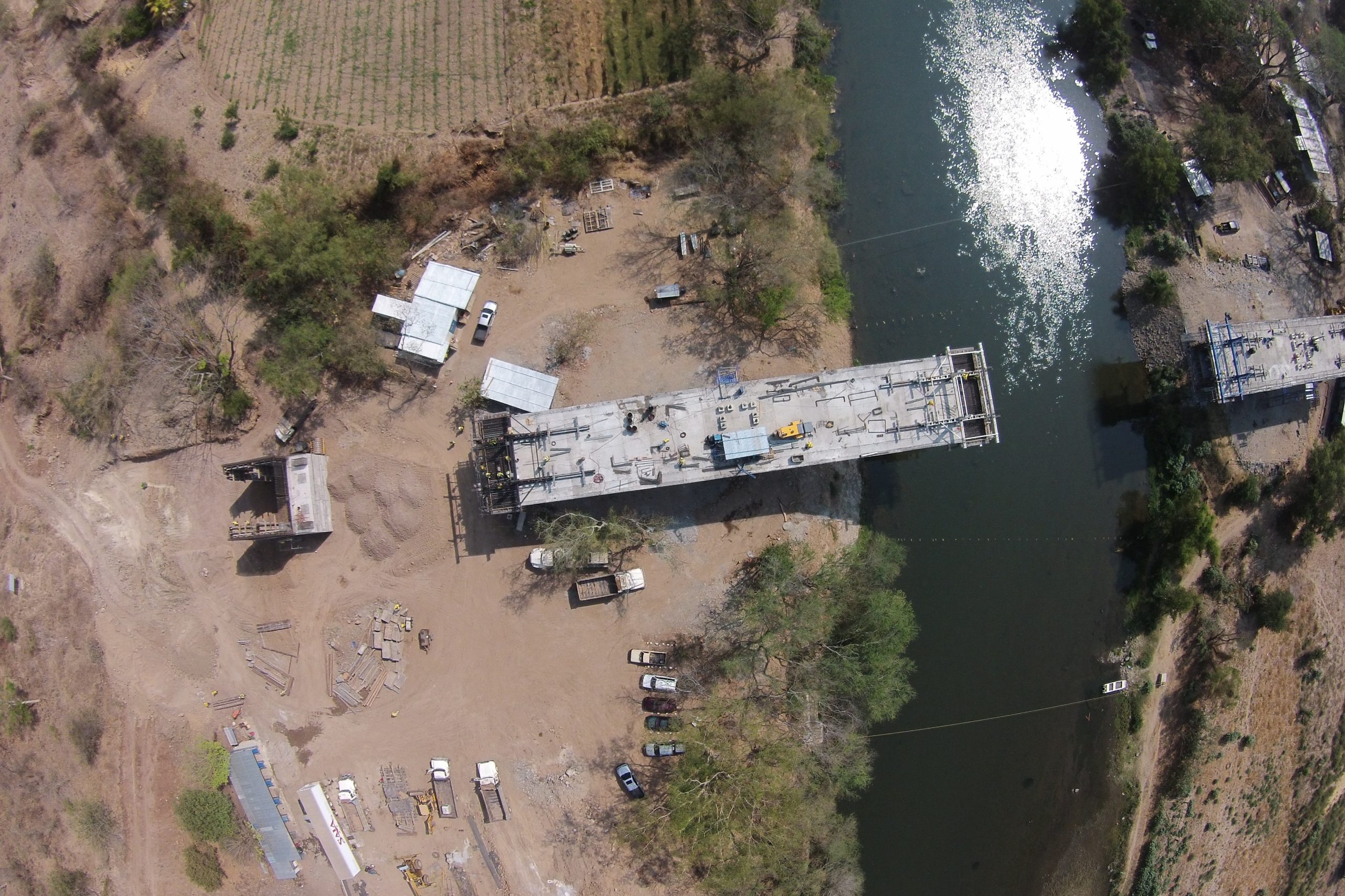 An aerial shot of construction process of a bridge over a river